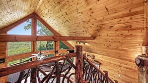 A wooden interior with a sloped ceiling, large windows, and a rustic wooden railing. - Early Rise - Blue Ridge  (Blue Ridge)