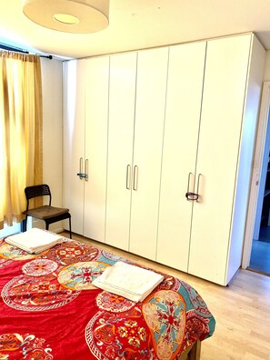 Comfortable room with a large wardrobe and a cozy bed.