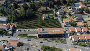 Vista aérea de un área residencial con un edificio grande de techo plano y un estacionamiento.