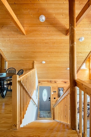 Staircase leads to an upper level with a door featuring a decorative glass panel.