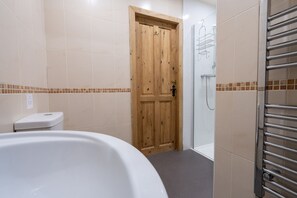 Bathroom features a bathtub and glass shower enclosure.