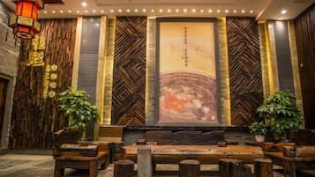 A lobby with a stage, seating area, and decorative elements.