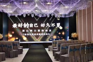 A stage with a backdrop and seating arranged in rows. - Hengsheng Kejia Courtyard (Xinfeng)
