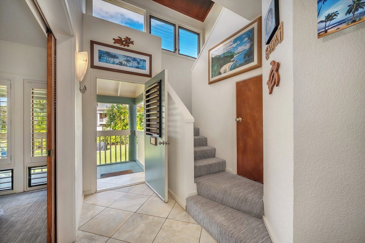 A staircase leading to a balcony with a view of the outdoors.