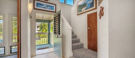A staircase leading to a balcony with a view of the outdoors.