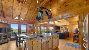 A wooden cabin interior with a kitchen, dining area, and living room. - 🌄Sleeps up to 16 🌄 Pristine Mountain Views from Downtown Helen ⛰️ (Helen)