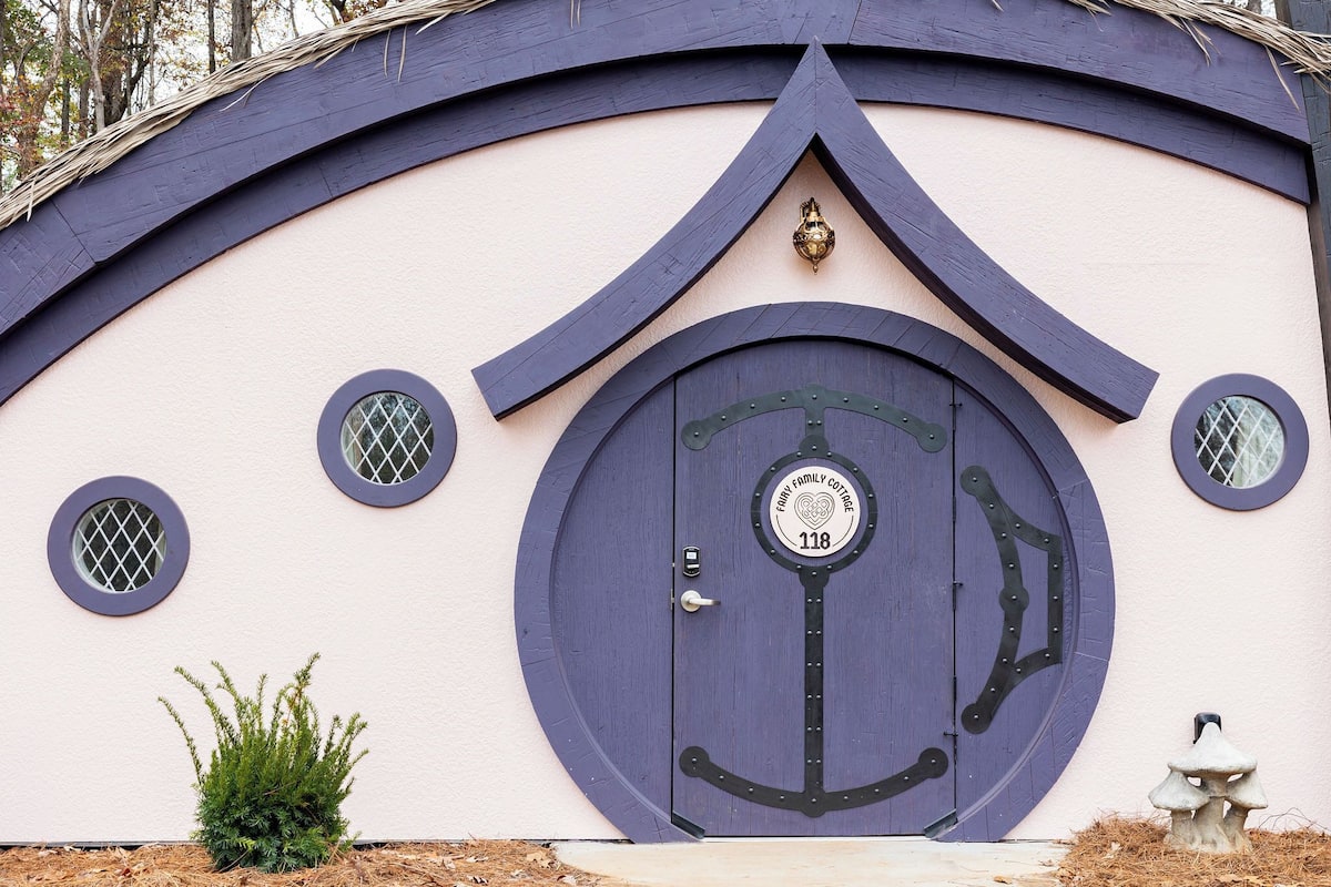 A house with a unique circular door, a small window, and a mailbox.