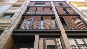 A multi-story building with a modern facade, featuring large windows and a mix of decorative and plain elements. - Galata Rasso Boutique Hotel (Istanbul)