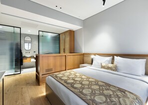 A modern hotel room with a large bed, a wooden wardrobe, a glass shower enclosure, and a bathroom with a large mirror and sink. - Galata Rasso Boutique Hotel (Istanbul)