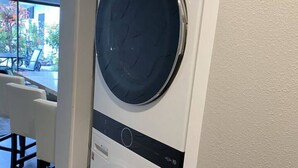 A front-loading washer and dryer unit in a residential setting.