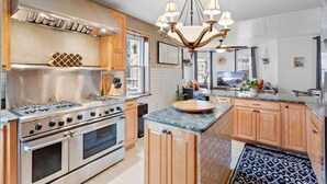 A modern kitchen with stainless steel appliances, wooden cabinets, and a central island. - Unique 5BD/3BA near Hard Rock, Ocean & Boardwalk (Atlantic City)