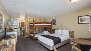 A bunk bed room with a desk and kitchenette. - Birch Glen Lodge (Cascade)