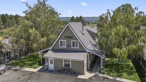 A lodge with a sloped roof, a front porch, and a sign indicating an office. - Birch Glen Lodge (Cascade)