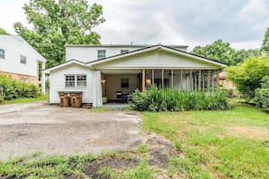 A two-story house with a covered porch and a small attached garage.