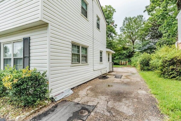 A two-story house with a driveway leading to the front door. - Near Midtown, Highways, Downtown! Bel-Air Bungalow (Mobile)