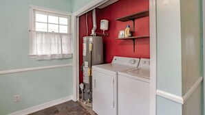 A laundry room with a washing machine, dryer, and a water heater. - Near Midtown, Highways, Downtown! Bel-Air Bungalow (Mobile)