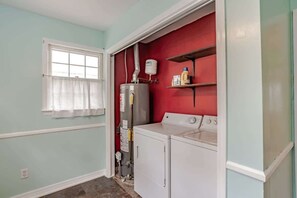 A laundry room with a washing machine, dryer, and a water heater. - Near Midtown, Highways, Downtown! Bel-Air Bungalow (Mobile)