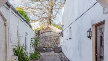 Step into a charming courtyard with a seating area, perfect for relaxation or socializing.