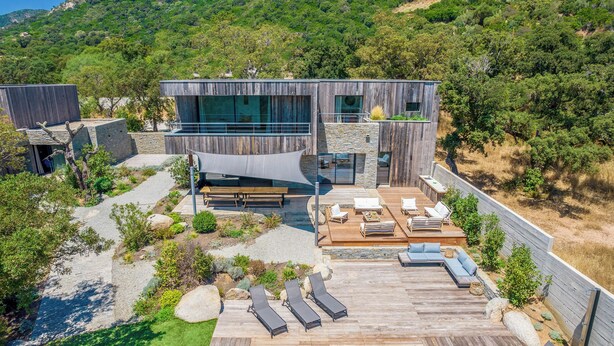 A modern villa with a pool, outdoor seating, and a view of the surrounding hills. - Superb Villa with pool, sea & maquis views. Terrace 400m from the beach! (Sainte Lucie de Porto-Vecchio)