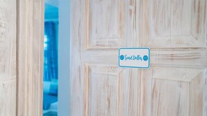 A wooden door with a sign that reads "Sand Dollar."