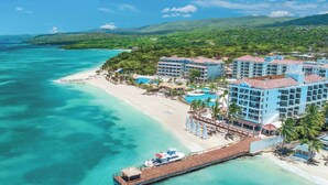 A resort with multiple buildings, a beach, and a pier. - Sandals Dunns River - All-inclusive Adults Only (Ocho Rios)