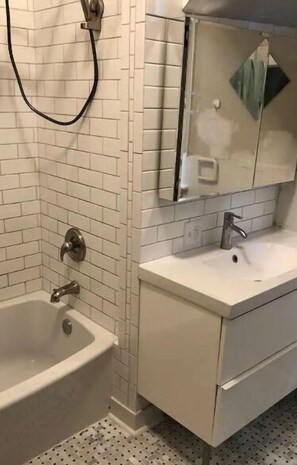 Bathtub, hair dryer, towels, soap