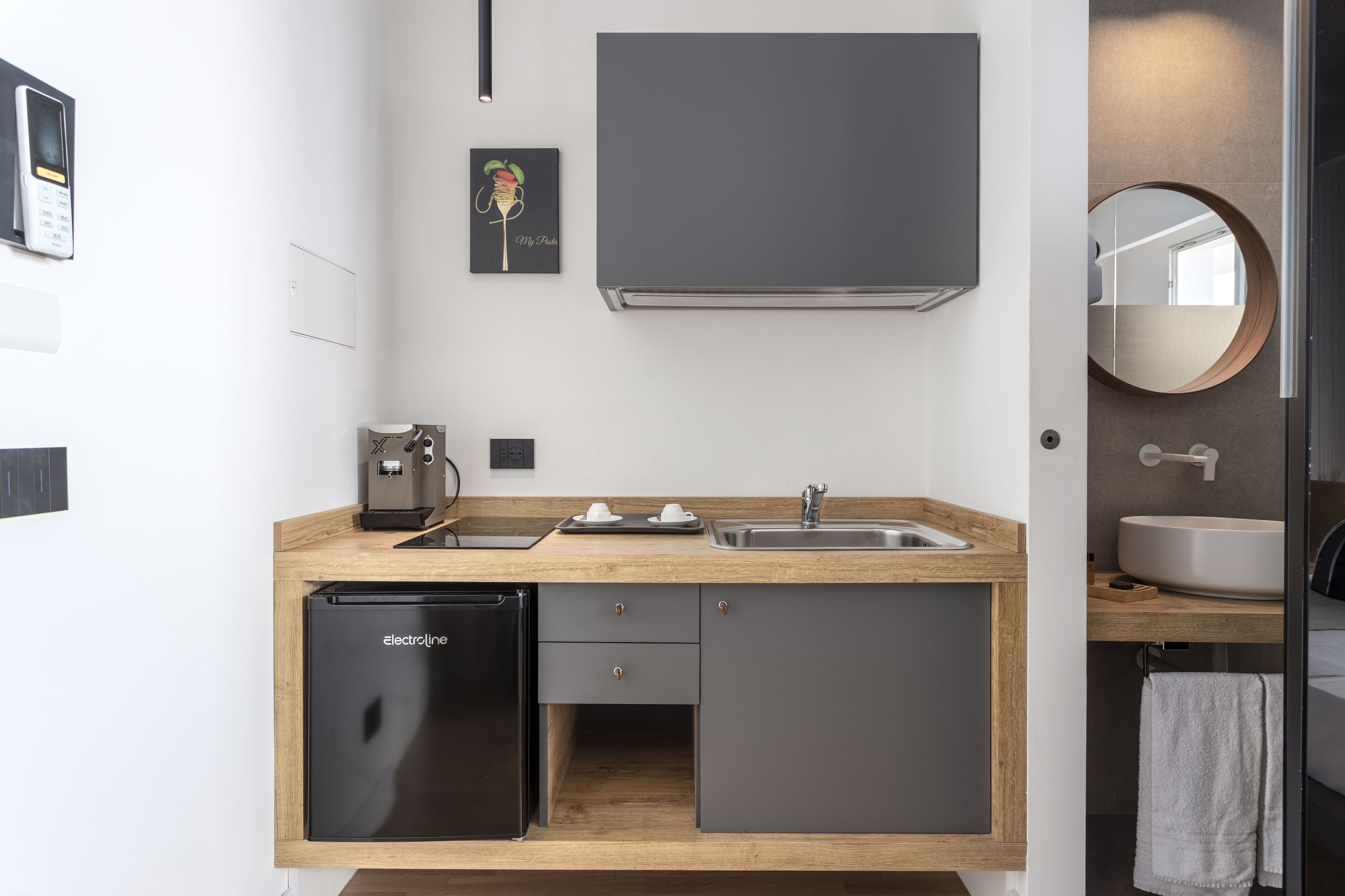 A modern kitchen with a built-in dishwasher, a sink, and a coffee maker.