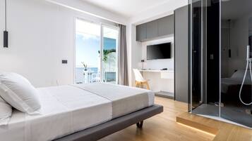 A modern bedroom with a bed, a TV, and a shower area.