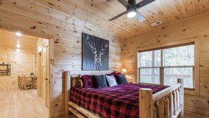 A wooden cabin bedroom with a bed, a ceiling fan, and a window. - ⛰️Li'l Red Express Cabin in Pigeon Forge🌄Close to Dollywood🎢 & The Island  (Pigeon Forge)