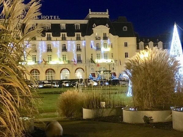 A hotel with a classic European architectural style, featuring a symmetrical facade with multiple windows and a central entrance.