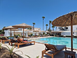 2 outdoor pools, open 10:00 AM to 6:00 PM, pool umbrellas, pool loungers