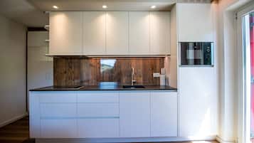 Fridge, microwave, coffee/tea maker, cookware/dishes/utensils