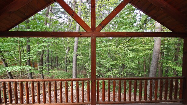 A wooden deck with a view of a forest. - Destiny's Daydream - Couple's Cabin- Hocking Hills (Logan)
