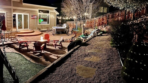 A patio area with outdoor furniture, a barbecue grill, and a small pool.