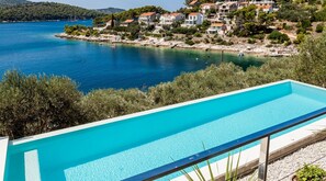 A swimming pool with a clear view of a coastal town and the sea. - Villa Belvedere - Two Bedroom Villa with Swimming Pool and Sea View (Vela Luka)
