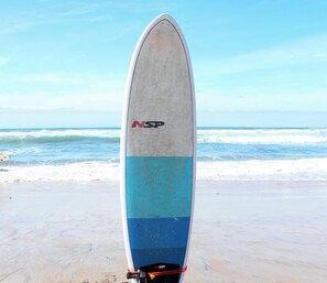 A surfboard with the NSP logo on a beach. - Modern Retreat Steps to the Beach! (San Diego)