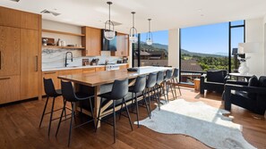 Enjoy cooking in this well-lit kitchen with a large island, bar stools, and a countertop.