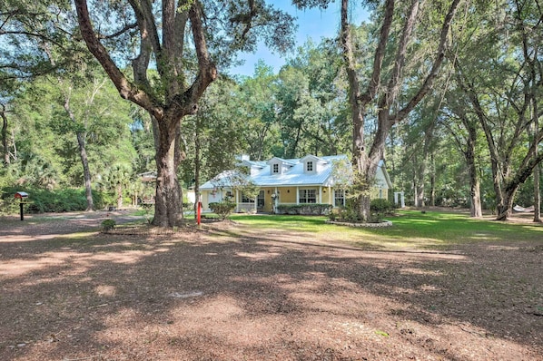 A house surrounded by large trees in a wooded area.