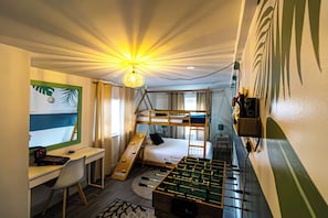 A compact room with bunk beds, a desk, a foosball table, and a wall-mounted shelf. - Salt and Sage Stay I Designer 4BR/2 Bath Retreat I Plunge Pool I 10 min to Beach (hollywood)
