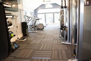 Stay active with our fully equipped gym featuring treadmills, a stationary bike, and weight machine.