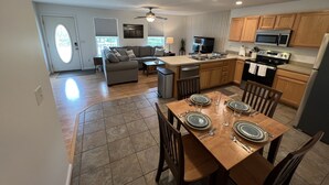 A modern kitchen with wooden cabinets, a built-in microwave, and a stainless steel refrigerator. - Relaxing 2 bedroom home minutes away from PMRP (Beattyville)