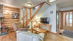 A cozy living room with a fireplace, a sofa, a coffee table, and a television. - Cozy Mountaintop Retreat < 6 Mi to Ski Cloudcroft! (Cloudcroft)