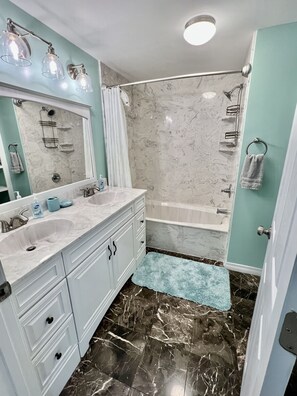 Combined shower/tub, hair dryer, towels, soap