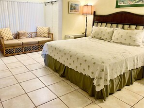 A bedroom with a bed, a sofa, a nightstand, and a lamp. - Beachside, Pool, Amazing Views, Excellent Location - 3bedroom/3bathroom Condo (St Thomas)