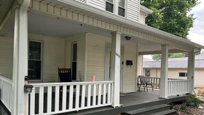 A two-story house with a covered porch and a front door. - Great Rural hideaway-20 minutes from peoria (Chillicothe)