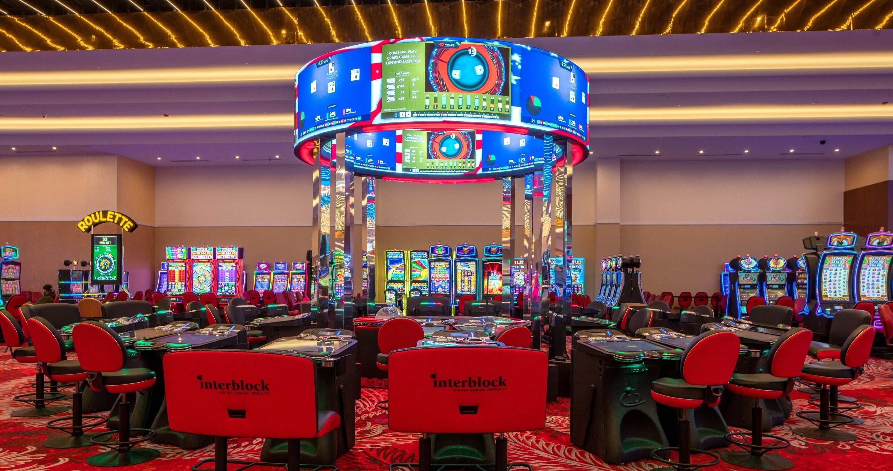 A casino with multiple slot machines and blackjack tables.