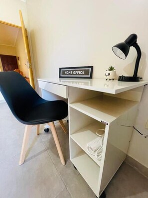 Work from anywhere in this cozy space with a dedicated desk, comfortable chair, and natural light.