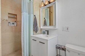Combined shower/bathtub, hair dryer, towels, toilet paper