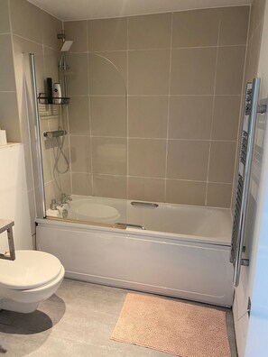 Bathtub, hair dryer, towels, soap