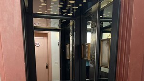 An elevator with a modern design, featuring a metallic interior and a glass door. - Your Home in Florence next to the central train station (Firenze)